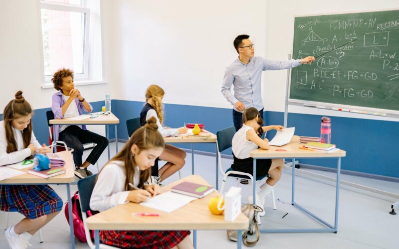 teacher writing on blackboard