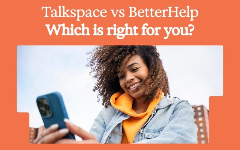 smiling woman looking at her phone with an orange background